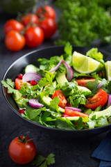 avocado, tomato and arugula salad. Healthy vegan food.