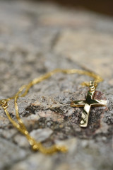 Golden cross on rock