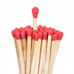 One matchstick standing over from the group, leader concept