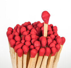 One matchstick standing over from the group, leader concept