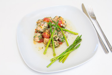 Salmon baked with tomato, capers and asparagus