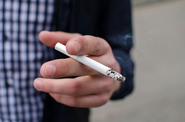 Young man smoking cigarette 