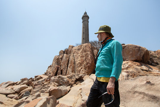 A young man travels through Vietnam. Travel concept. Ke Ga Lighthouse