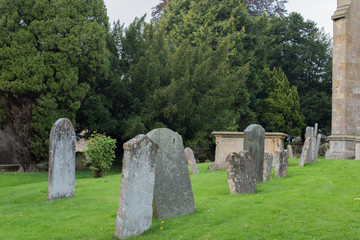 Naklejka premium old tombstones on churchyard of St James in Chipping Campden, England