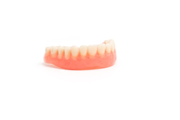 upper dentures on white background
