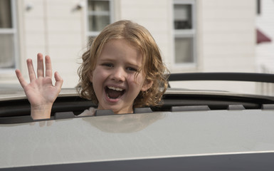 Vehicle with open roof and a child looking out - October 2016 - Little girl waving from a sunshine...