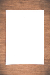 Close up White notebook paper on grunge wood background