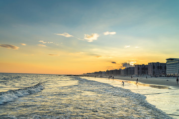 Long beach at the evening. Summer weather, splittoned image