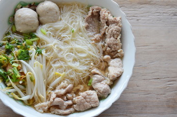 thin rice noodle with pork ball in soup on bowl