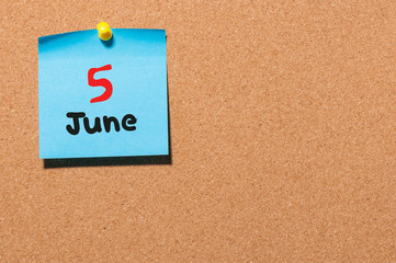June 5th. Day 5 of month, color sticker calendar on notice board. Summer time. Empty space for text