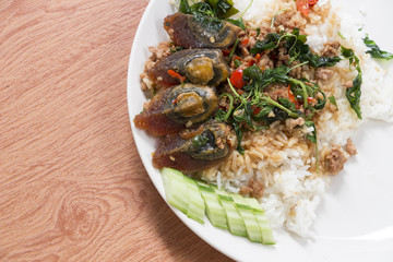 Fried rice preserved egg and place on a plate.