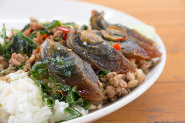 Fried rice preserved egg and place on a plate.