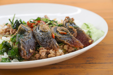 Fried rice preserved egg and place on a plate.