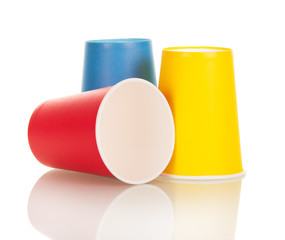 Bright disposable paper cups isolated on white.