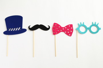 Photo booth colorful props for party - glasses, mustache, hat, ribbon on white background