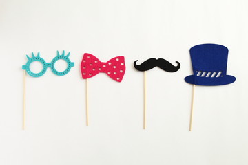 Photo booth colorful props for party - glasses, mustache, hat, ribbon on white background