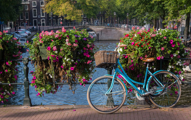 Fototapeta na wymiar Classic bicycle parked on canal bridge, Amsterdam, Netherlands