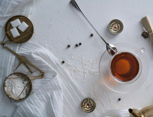 tea, scales, candles, letter on the table. space for text. top view.