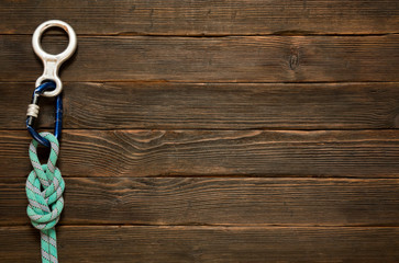 rock climbing and travel equipment on dark wooden background, to
