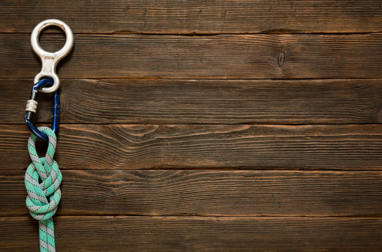 rock climbing and travel equipment on dark wooden background, to