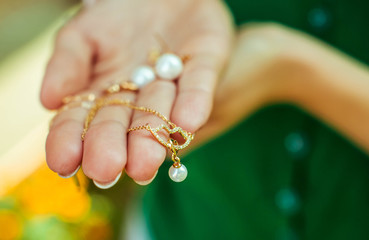 beautiful pendant in the form of pearls on hand