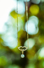 beautiful gold necklace with a pendant in the form of pearls