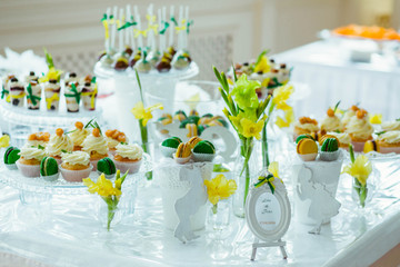 very nice sweet table with yellow and green goodies