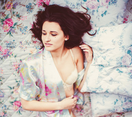 The beautiful bride lies on the bed