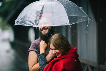 guy and girl under an umbrella © teksomolika
