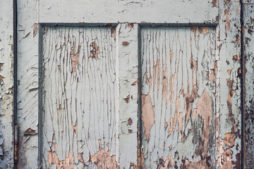 Fragment of old wooden door with peeling blue paint