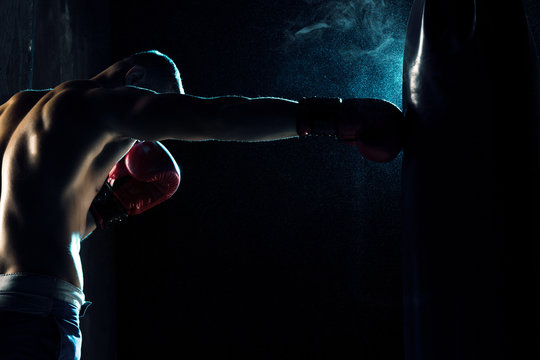 Male Boxer Boxing In Punching Bag