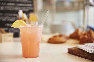 Glass of lemonade on the counter at a coffee shop, horizontal
