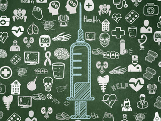 Health concept: Syringe on School board background