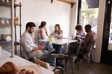 Five young adults hanging out at a coffee shop