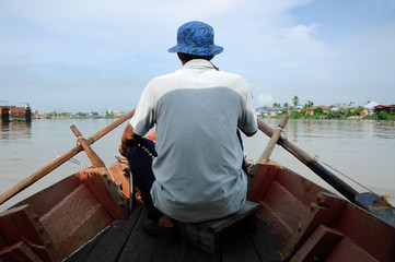 Boat operator was driving the boat. Most boat operators here earn a living by driving a boat full...
