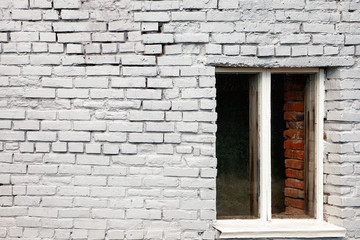 the window in front of a white brick wall