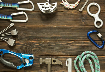 rock climbing and travel equipment on dark wooden background, to