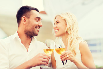 happy couple clinking glasses at restaurant lounge