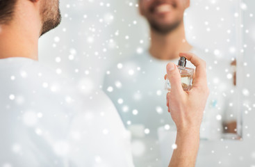 close up of man perfuming with perfume at bathroom