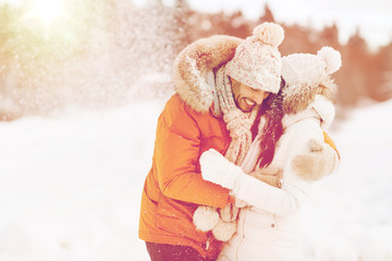 happy couple hugging and laughing in winter