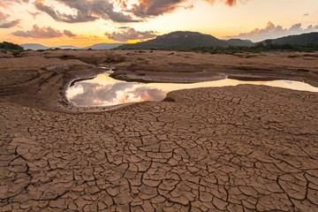 Fototapeta na wymiar cracked earth near drying water on twilight at at Sam Pan Bok in Ubonratchatani Province.Thailand