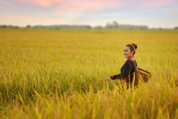 Naklejka na ściany i meble Beautiful Thai local woman working happy in the field,outdoor,thailand