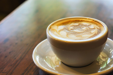 warm cup of coffee on brown background