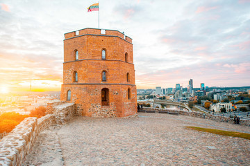 View on Gediminas tower on the castle hill during the sunset in the old town of Vilnius city in Lithuania. This tower is very popular tourist destination in Vilnius - obrazy, fototapety, plakaty