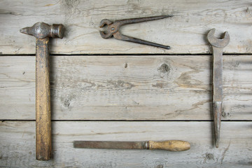 Old wooden desktop. Old rusty carpentry tools. Horizontal mockup