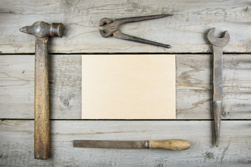 Old wooden desktop. Old rusty carpentry tools. Horizontal mockup