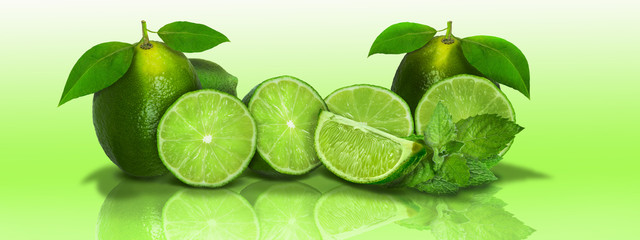 Sliced and whole limes in a panoramic  - 125711044