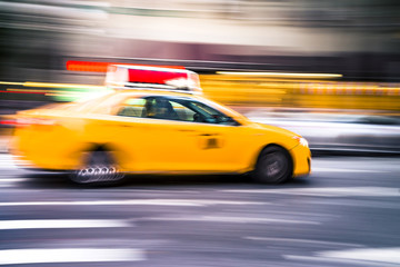 Fototapeta na wymiar NYC taxi in motion. Blurred, long exposure images.