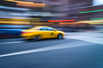 Fototapeta na wymiar NYC taxi in motion. Blurred, long exposure images.