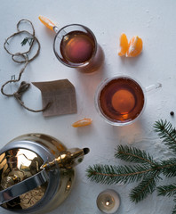 spruce branches, ribbons, tea, letter on the table. space for text. top view.
